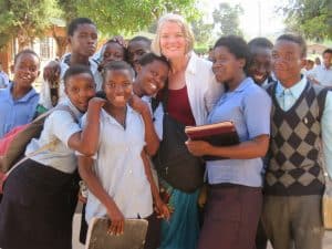 Karen McBride stands with children at the Zomba School.